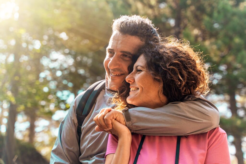 Joyful,Middle-aged,Couple,Embracing,In,A,Natural,Setting.,The,Man